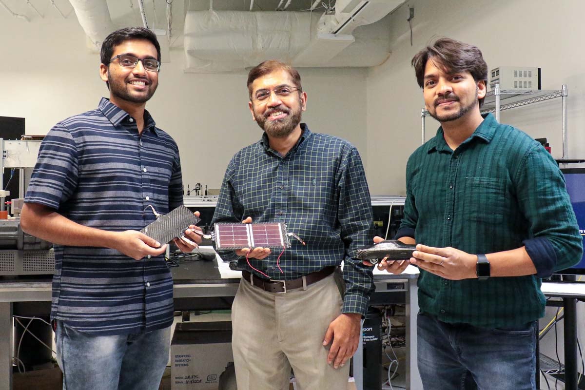 UCF researchers Kowsik Sambath Kumar, Jayan Thomas, and Deepak Pandey show the lightweight, supercapacitor-battery hybrid composite material they’ve developed.