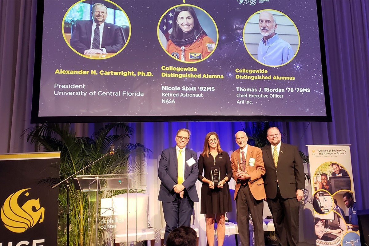 UCF College of Engineering and Computer Science Dean Michael Georgiopoulos, left, with UCF engineering alumni Nicole Stott'92 and Thomas J. Riordan'78 '79MS, and UCF President Alexendar Cartwright at the CECS Alumni Honors Reception Oct. 14.