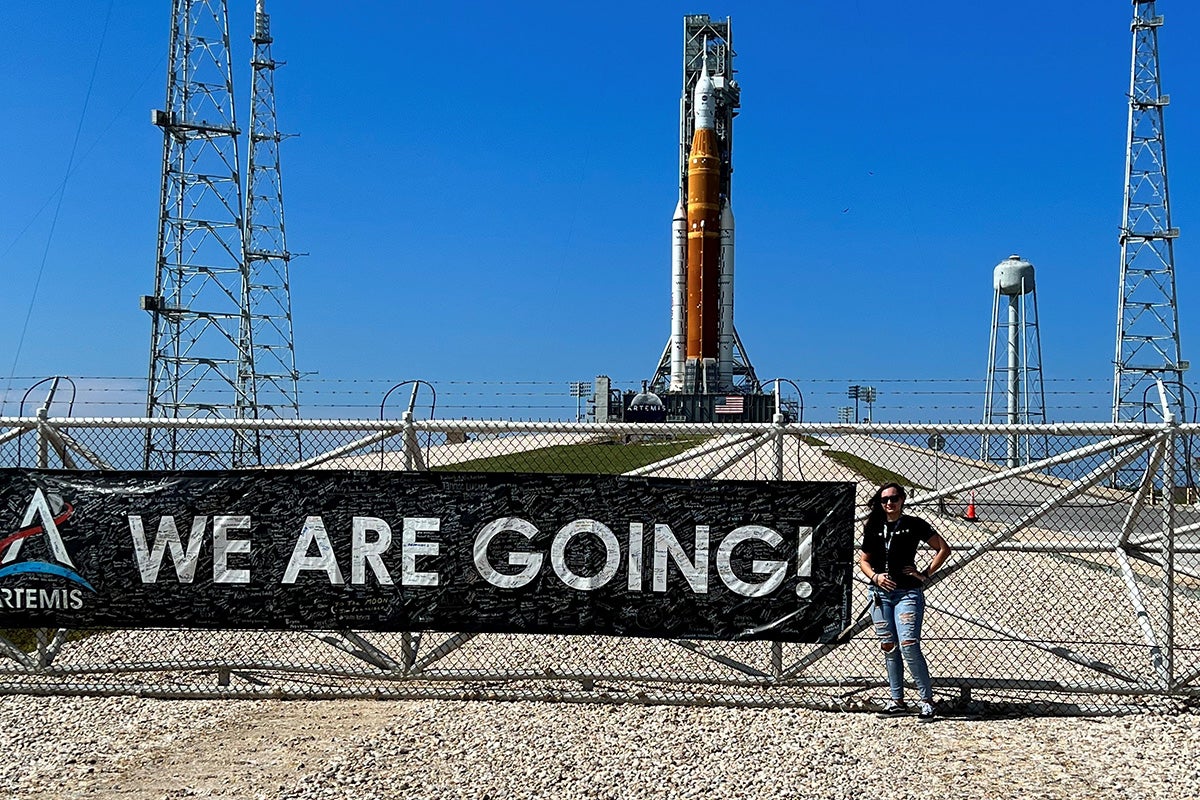 Taylor Peterson stands near the Artemis rocket