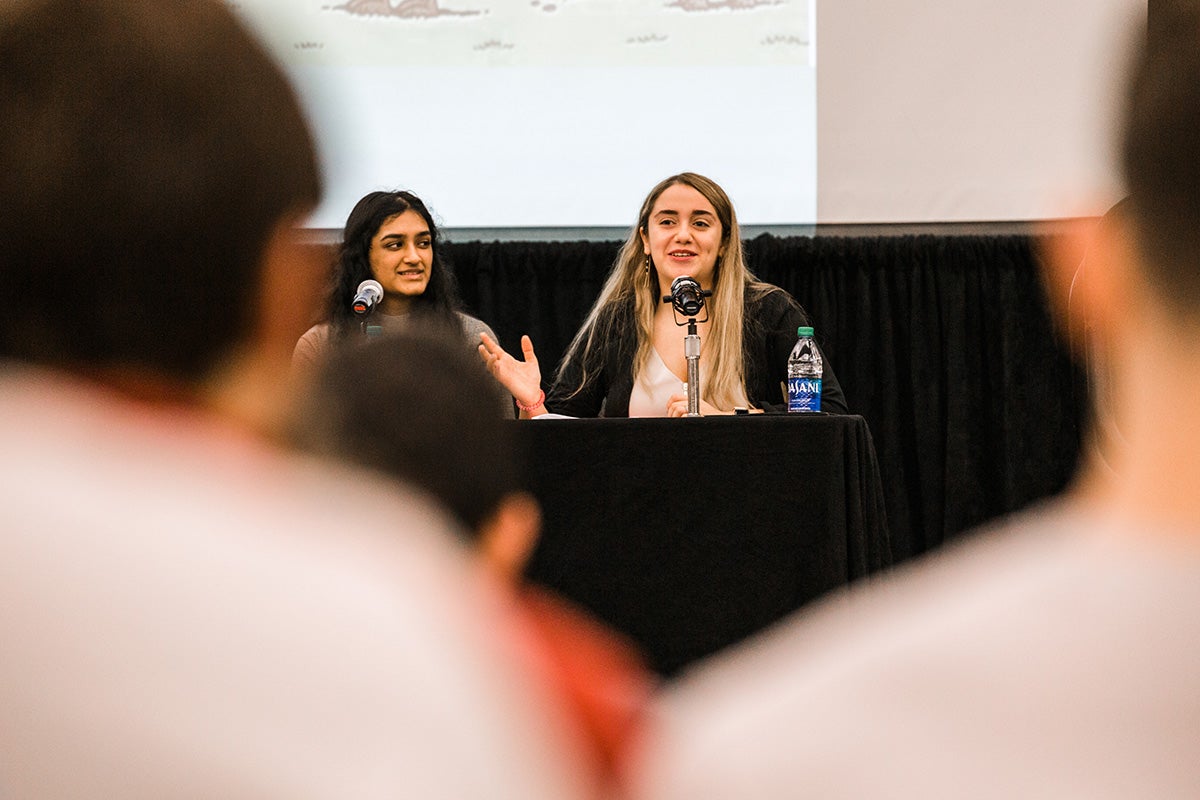 Students speaking on a panel