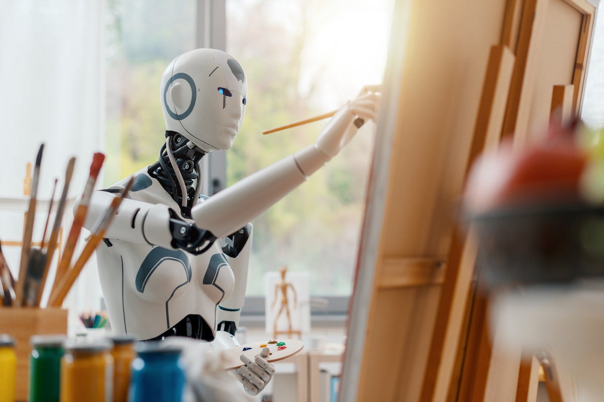 AI robot sitting down and painting in an art studio.