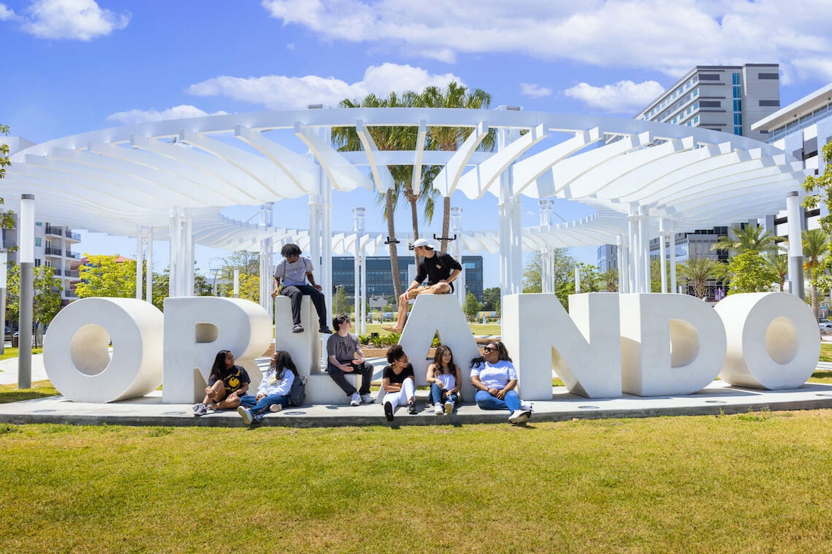 Students hang out near large letters spelling out "Orlando"