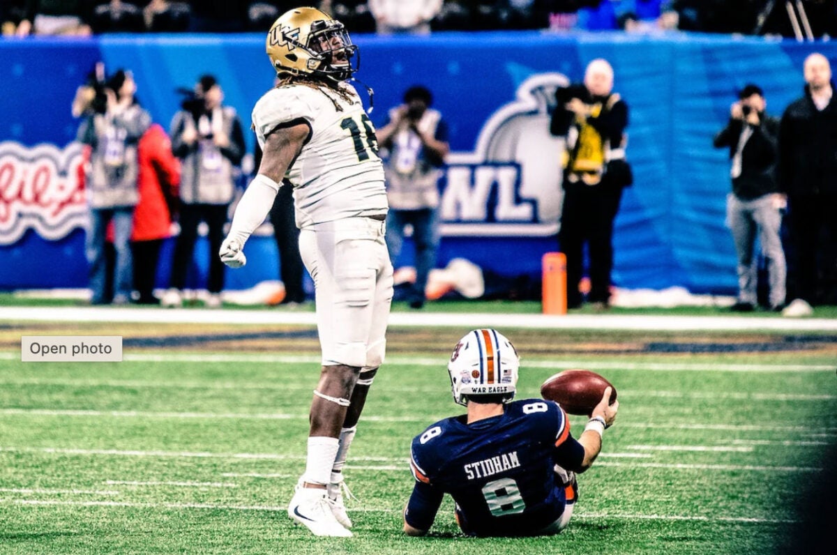 A UCF football player celebrates after tackling a player