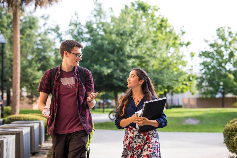 male and female students walking on UCF campus
