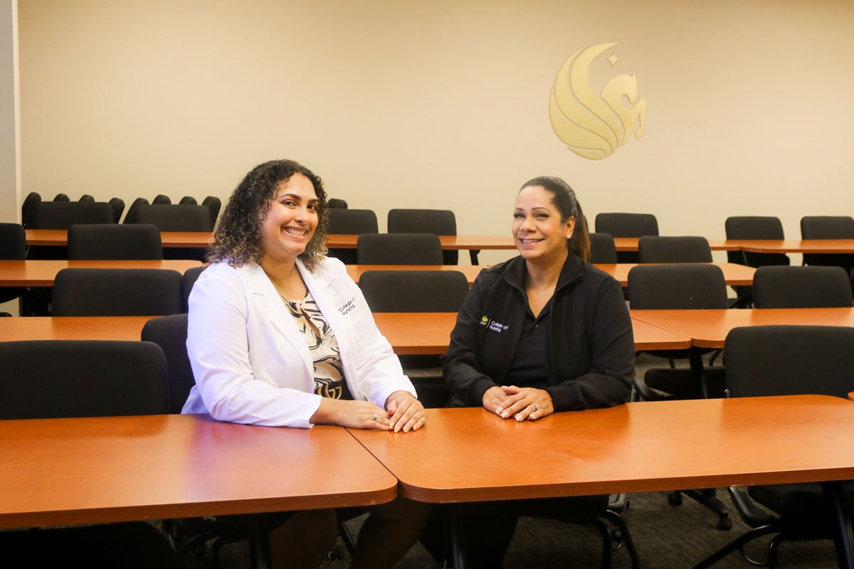 Aliyah Gonzalez and Donna Mercado sitting in a UCF College of Nursing classroom.