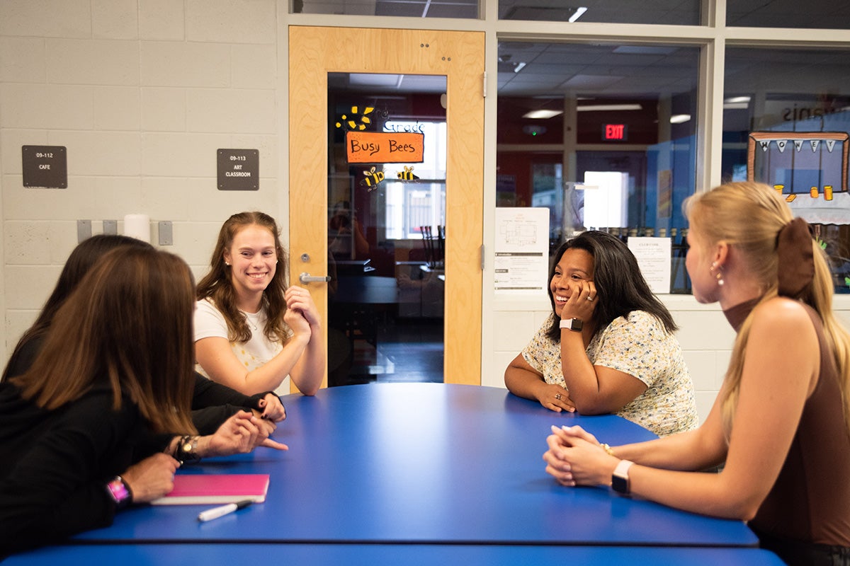 School counseling students in practicum at Orange County Public Schools’ Academic Center for Excellence (ACE) meet prior to seeing their clients for the day to debrief and discuss strategies for success. (Photo by Danielle Hendrix)