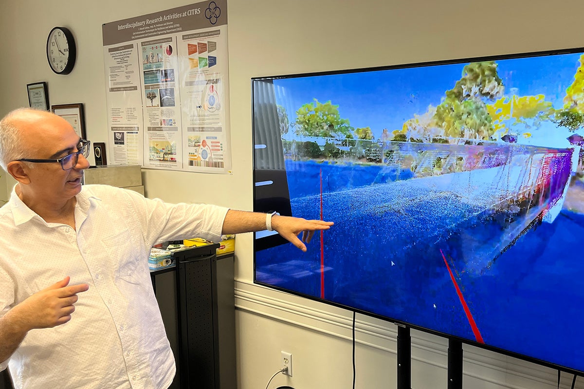 Necati Catbas shows the Virtual Visualization System. In the example, engineers located anywhere in the world with VR headsets are inspecting a particular bridge and seeing the structural health monitoring data simultaneously to aid their decision-making.