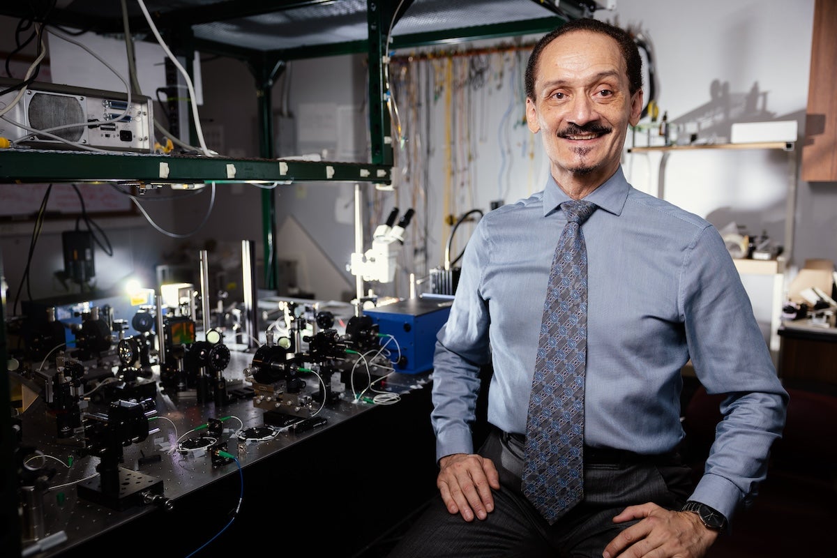 Peter Delyett poses for a photo in a lab