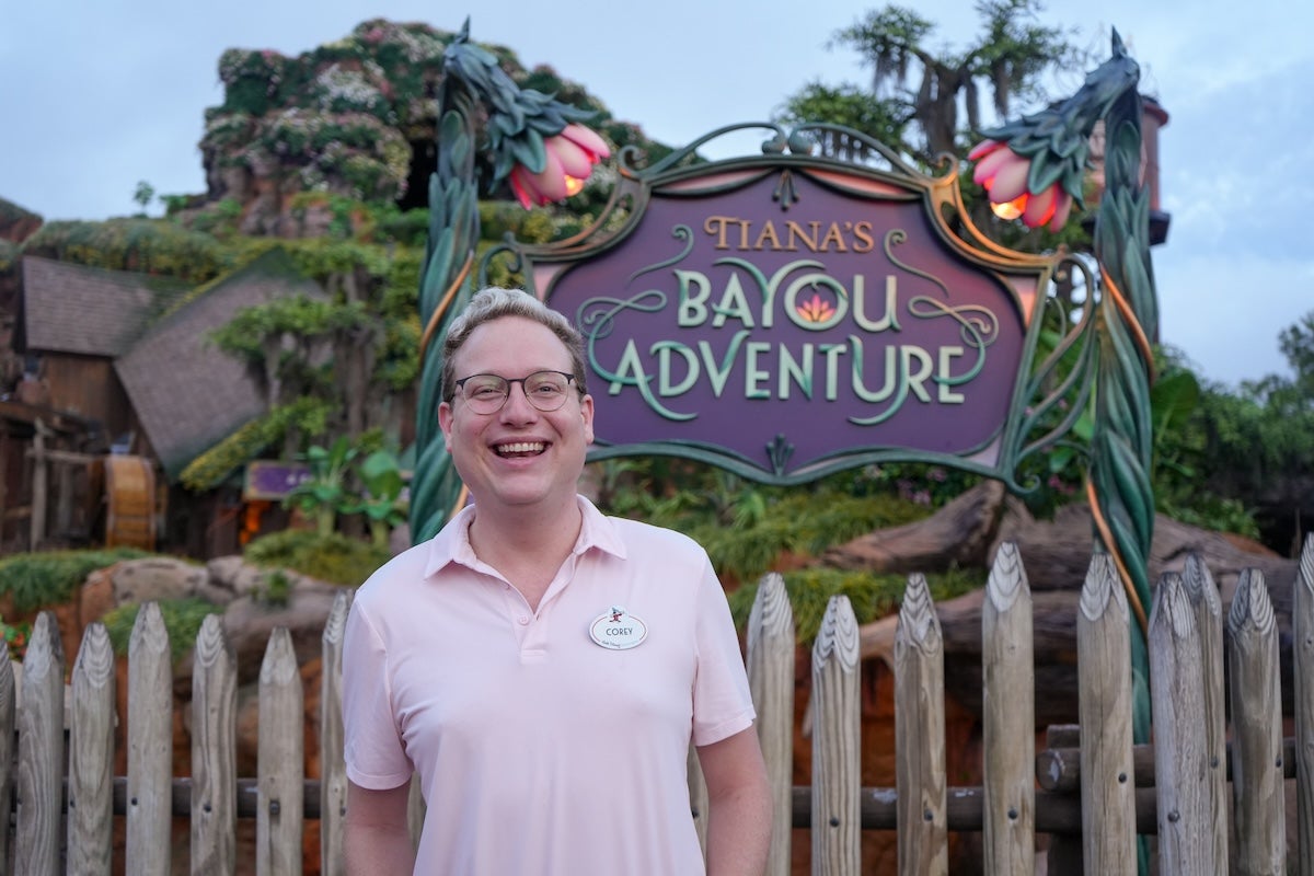 A man standing in from of the Walt Disney World Bayour Adventure ride.