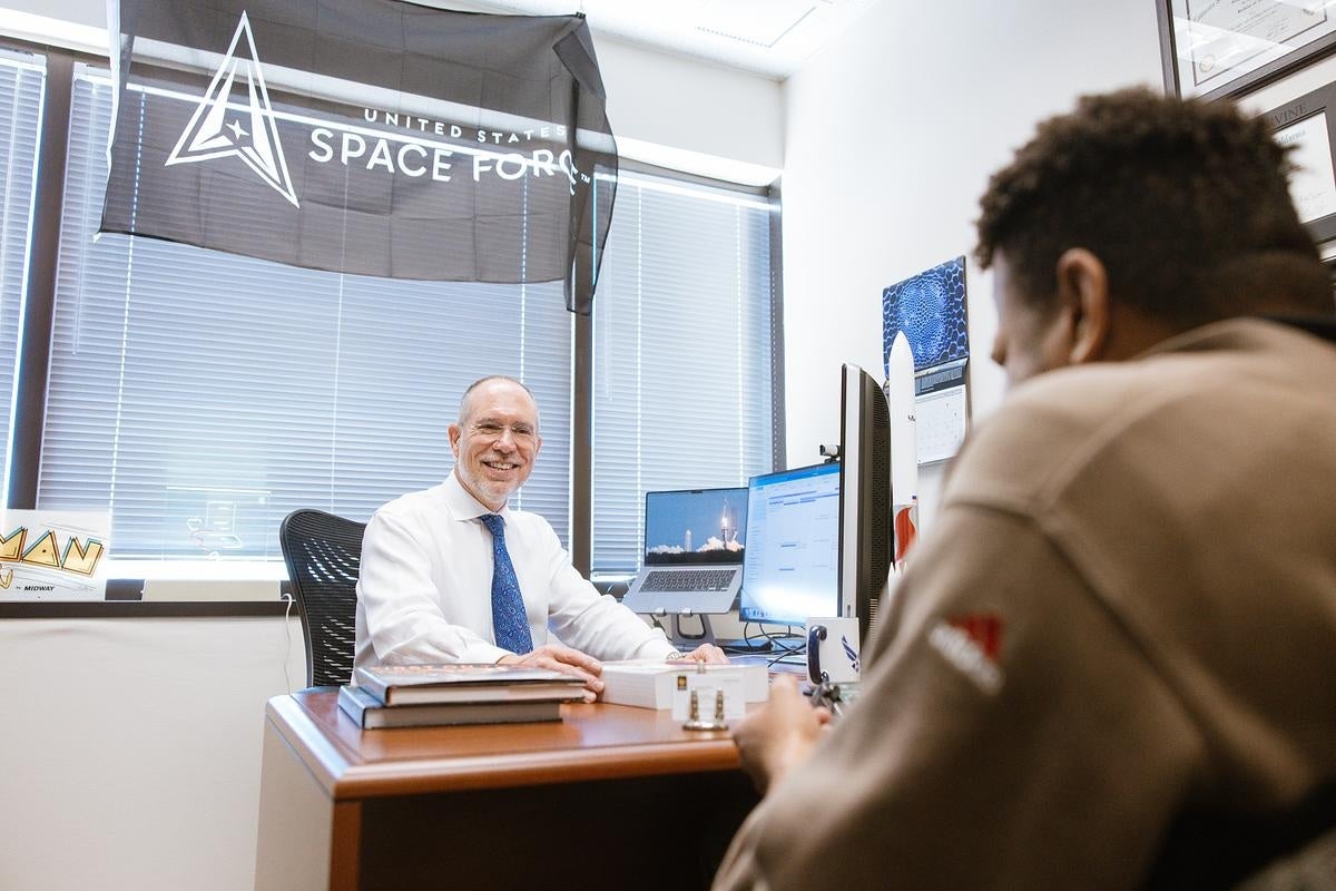 Greg Autry speaking with a student in his office