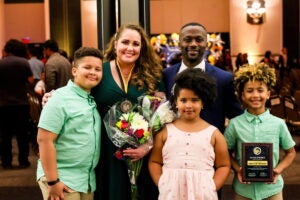 Two parents and three children standing up.