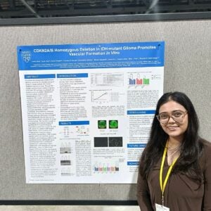Person standing up in front of research poster.
