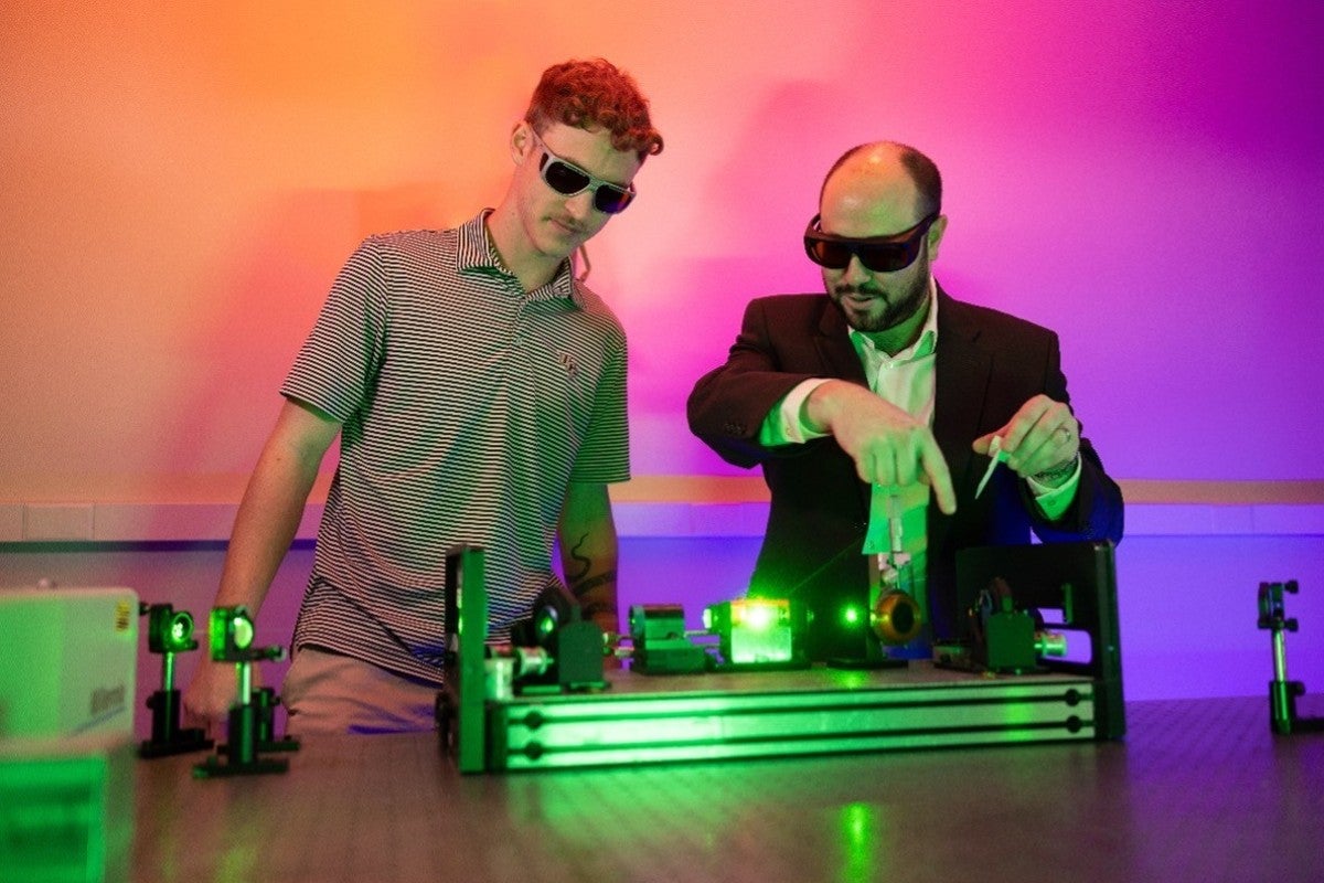 Two people looking at science equipment