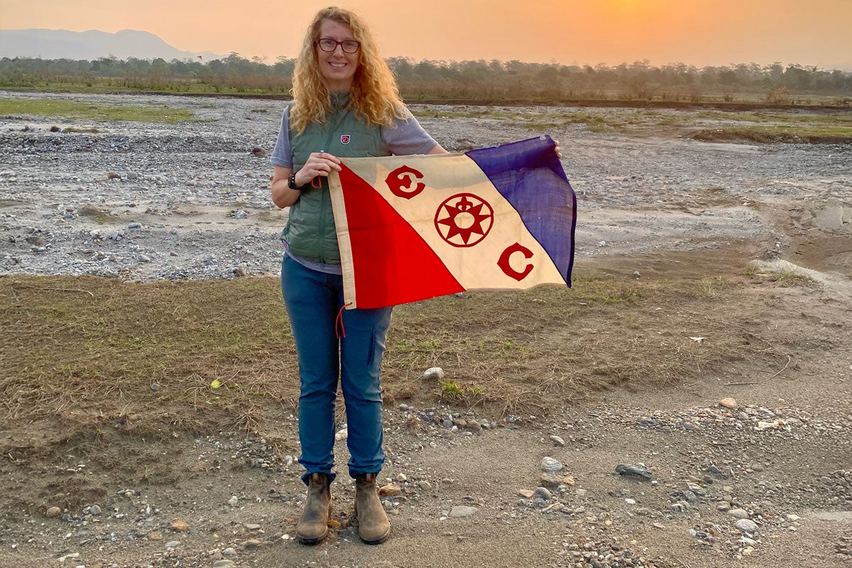 Tina Chiarelli holding the Explorers Club Flag