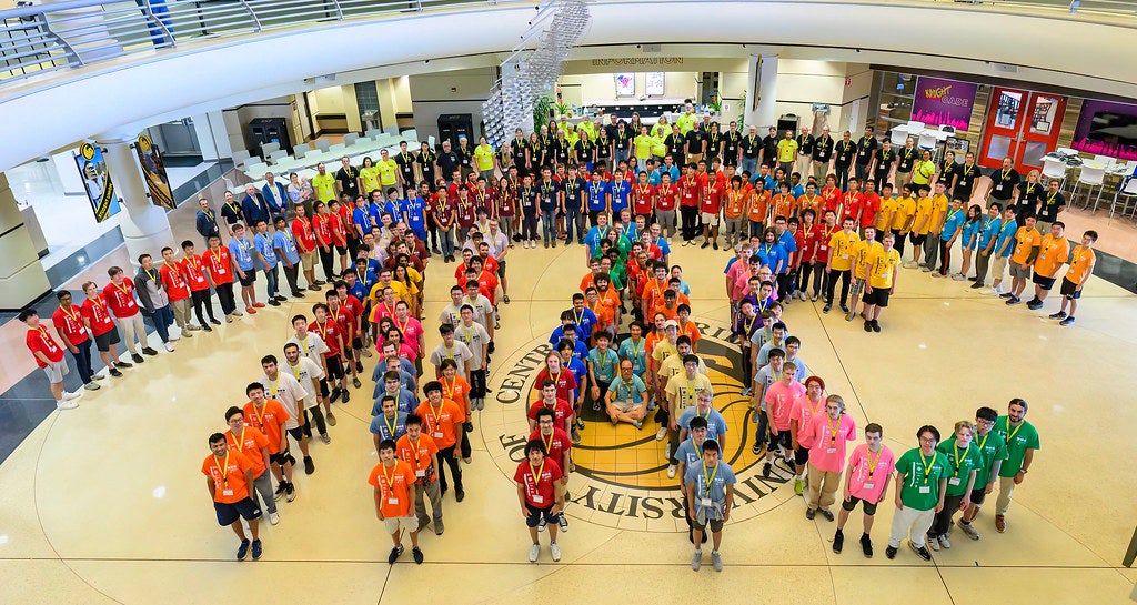 Students standing and spelling out the letters NAC