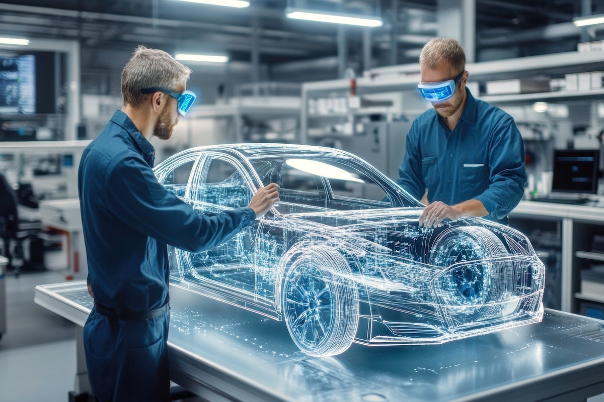 Two engineers using virtual reality technology to design a futuristic automotive prototype.