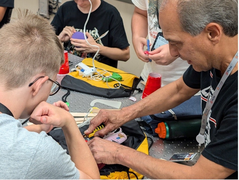 Professor works on soldering project.