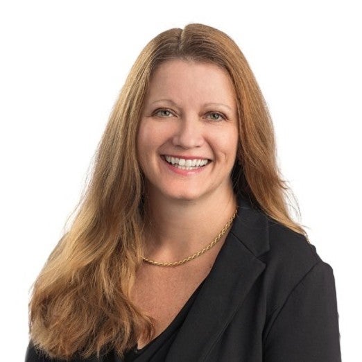 Person standing behind white background