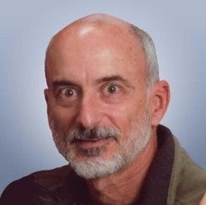 Person sitting in front of gray background