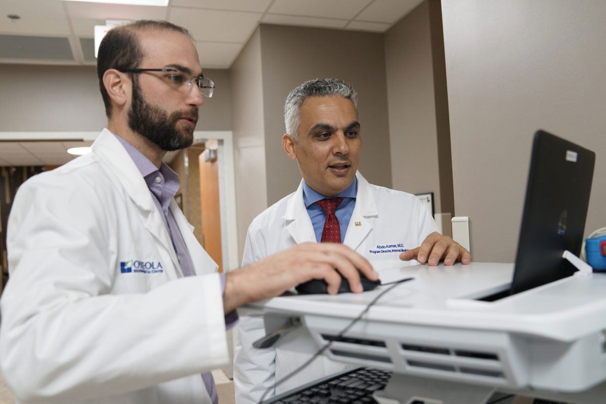 Two doctors working at a computer