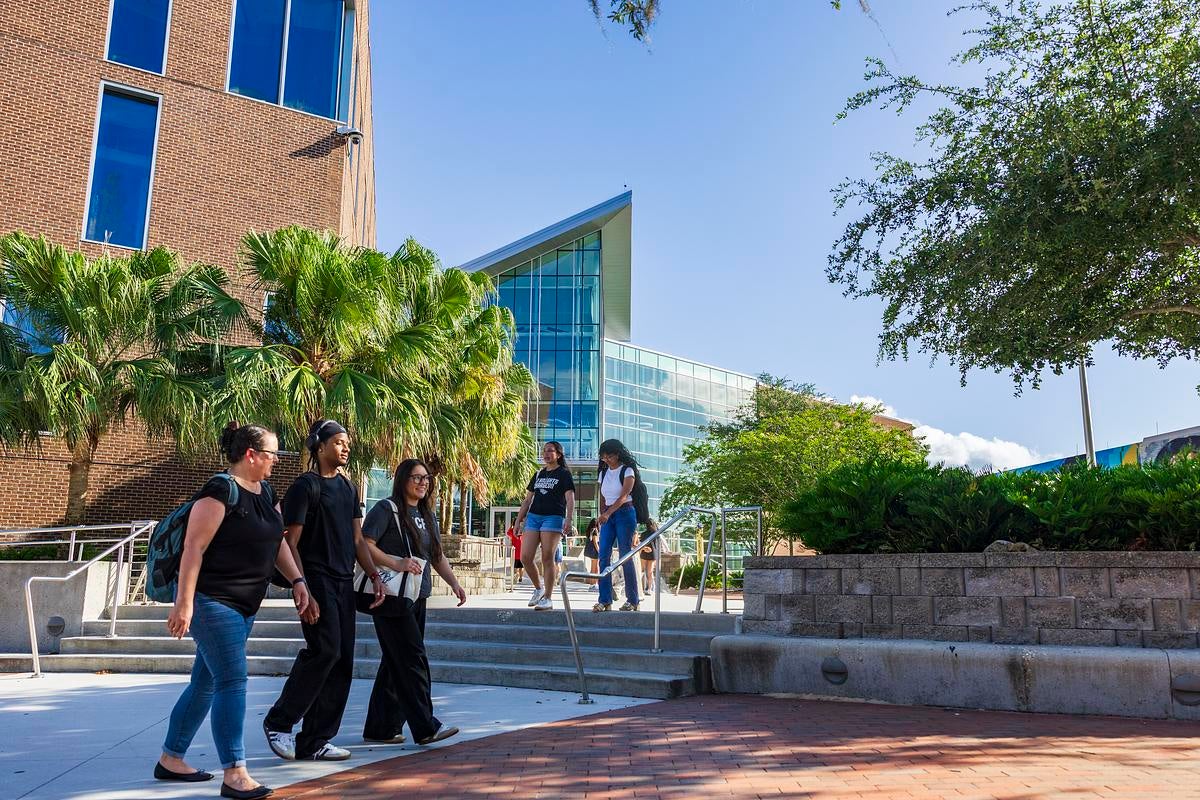 Students walking past the library.