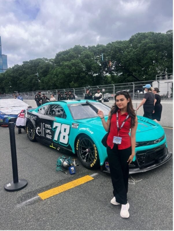 Person standing in front of race car
