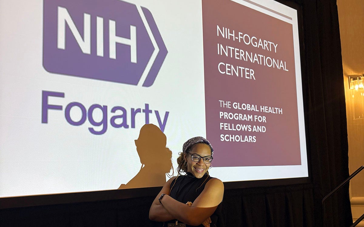 A student standing in front of a presentation.