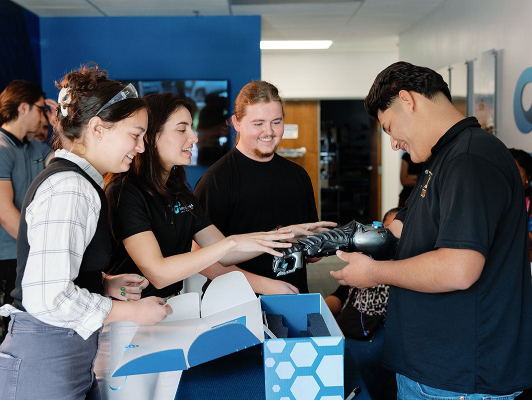 Incoming UCF medical student Viviana Rivera (second from left) works with colleagues at Limbitless Solutions to demonstrate the capabilities of a bionic arm. Rivera worked with Limbitless as graduate scholar and staff member during her undergraduate and graduate career. 