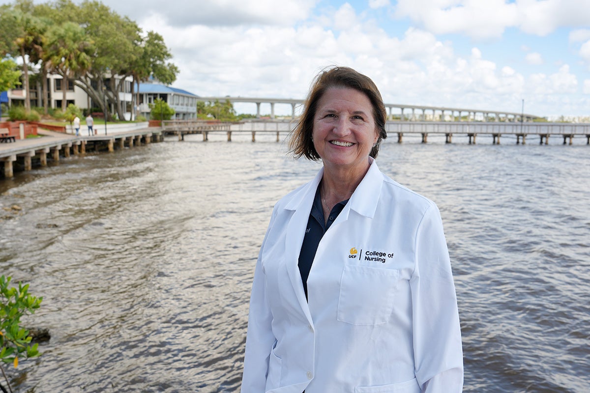 Rebecca Koszalinski, UCF College of Nursing associate professor, stands on a pier in Florida.