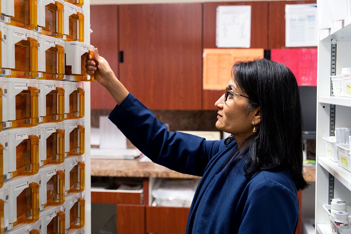 Dr. Binita Patel checks the number of pills in one of Pillbert’s 108 cassettes used to store medication.