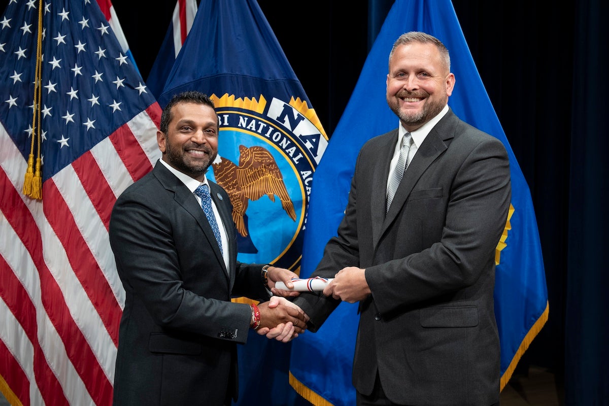 Federal Bureau of Investigation Director Kash Patel (left) and UCF Police Department Commander Christopher Gavette shake hands.