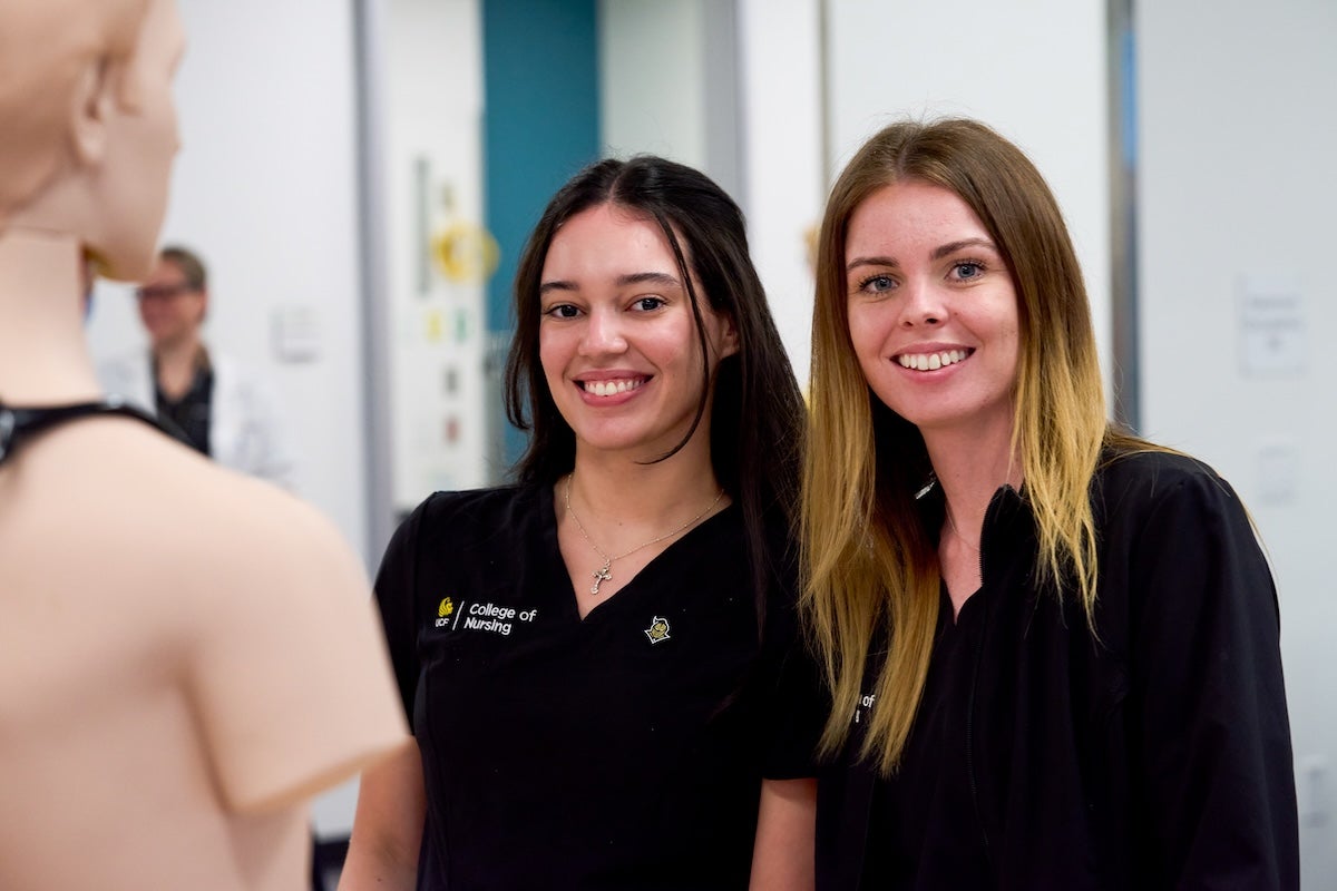 Two nursing students wearing scrubs