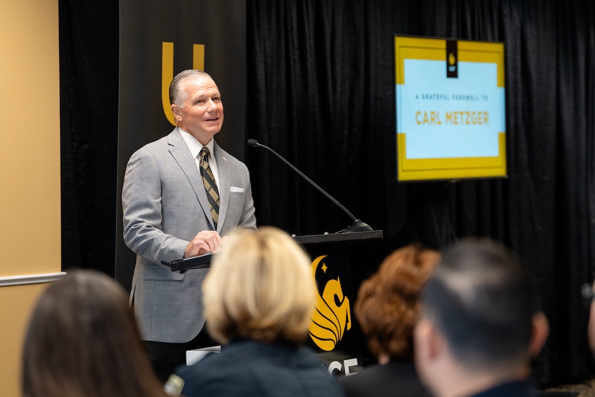 Carl Metzger, UCF’s associate vice president of public safety, addresses a room full of people during his retirement celebration.