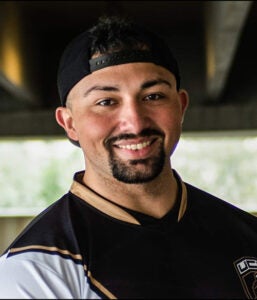 Portrait of male with goatee and backwards baseball cap