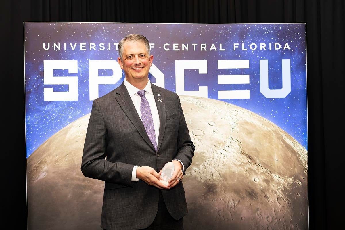 Robert Long holding an award
