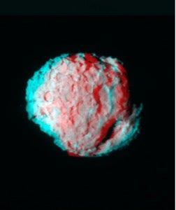 A 3D anaglyph stereo image of Comet Wild-2, created by combining two different images using cyan and red color channels, taken from slightly different angles to reveal the comet’s surface texture. 