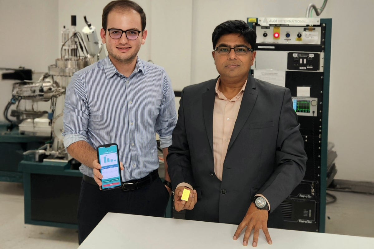 UCF researcher Debashis Chanda and doctoral student Mahdi Soudi stand together in a lab.