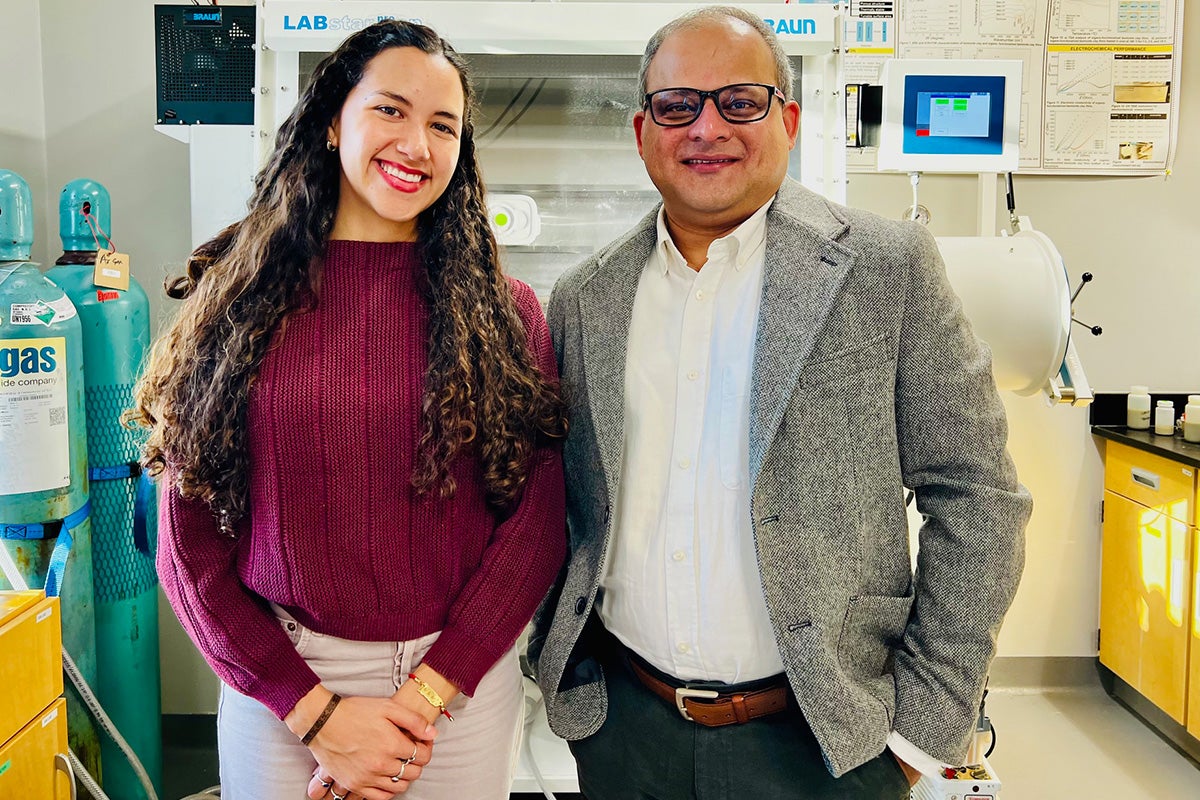 UCF Assistant Professor Kausik Mukhopadhyay stands next to doctoral student Amanda Bernard in a lab.