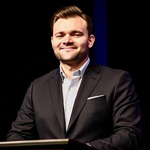 Portrait of man in business suit standing at podium