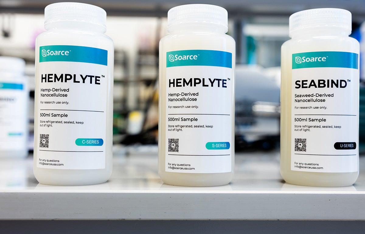 close-up of three bottles in a lab with white substance inside