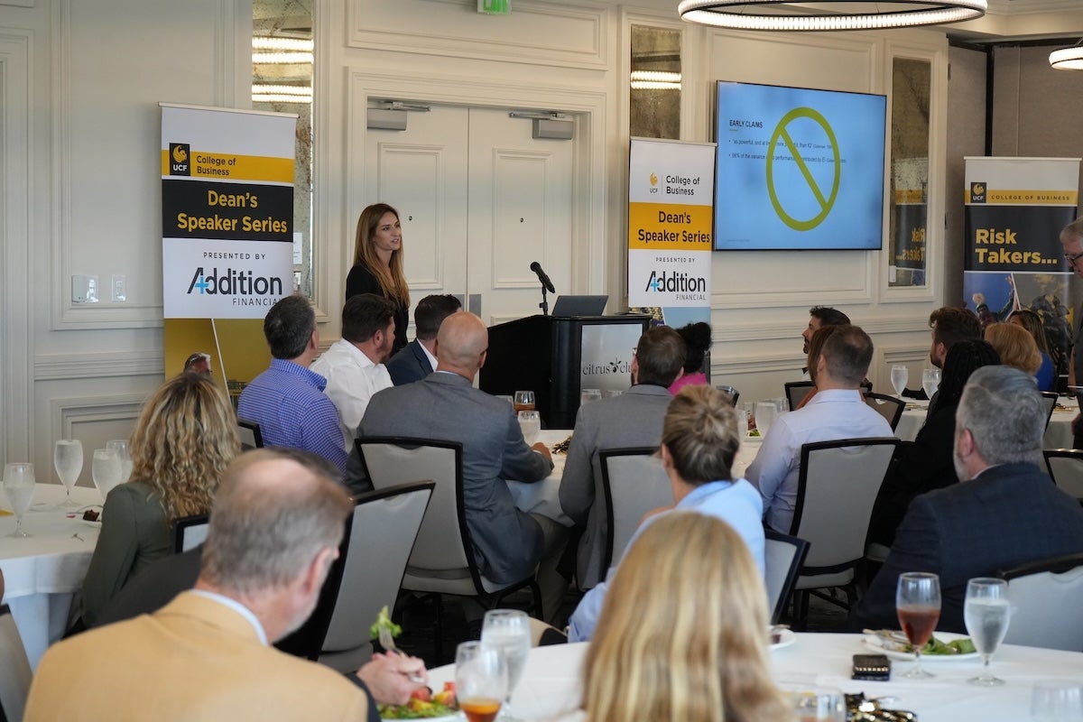 A professor speaking to a room of people