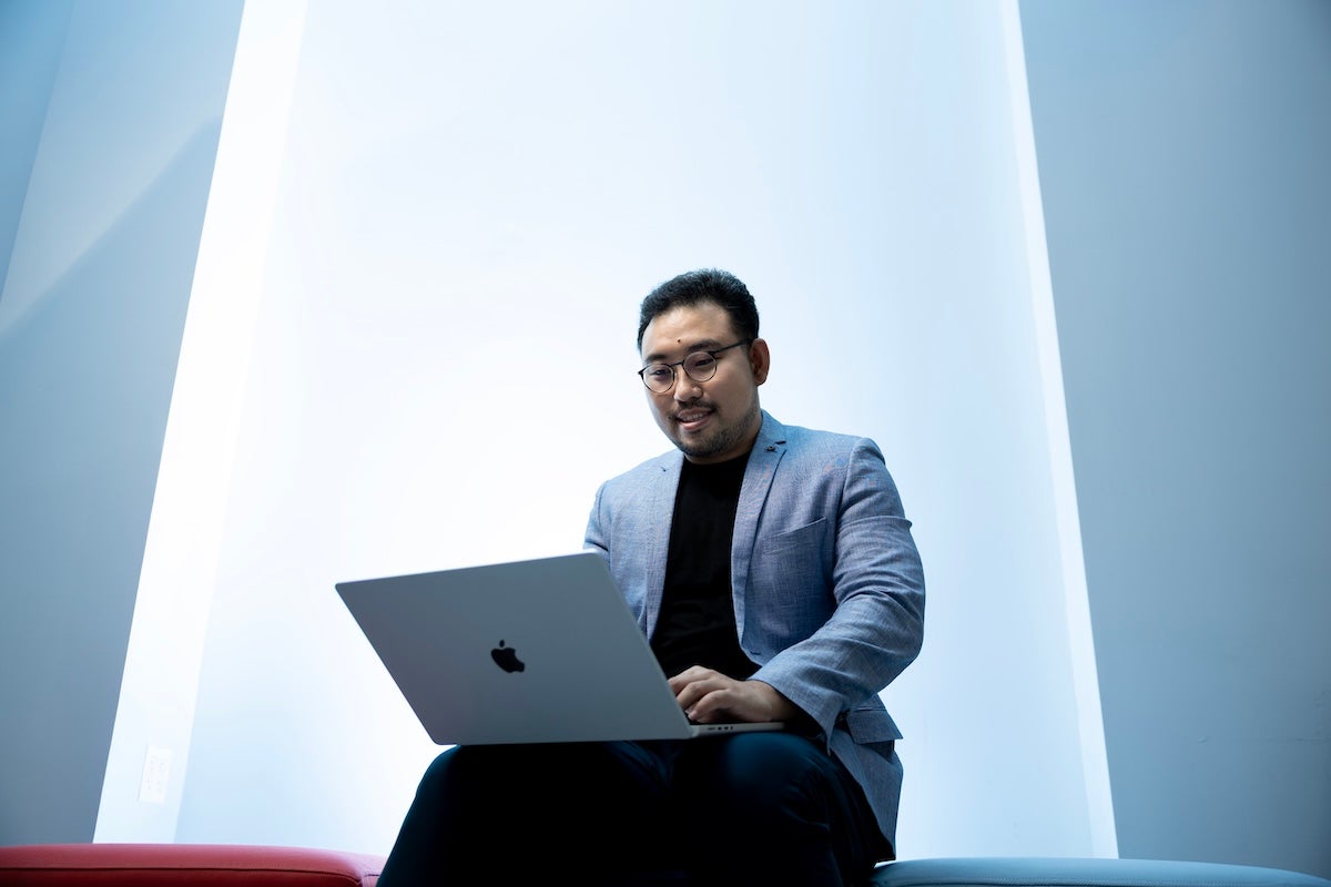 Yu Tian working on a laptop