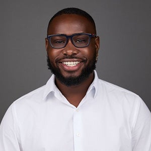 Portrait of smiling man with glasses in white collar shirt