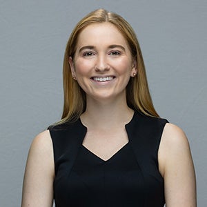 Portrait of smiling blonde woman in black sleeveless top