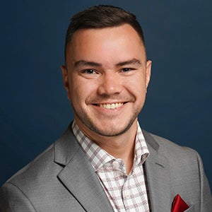 Portrait of smiling man in gray suit, checkered shirt and red pocket square