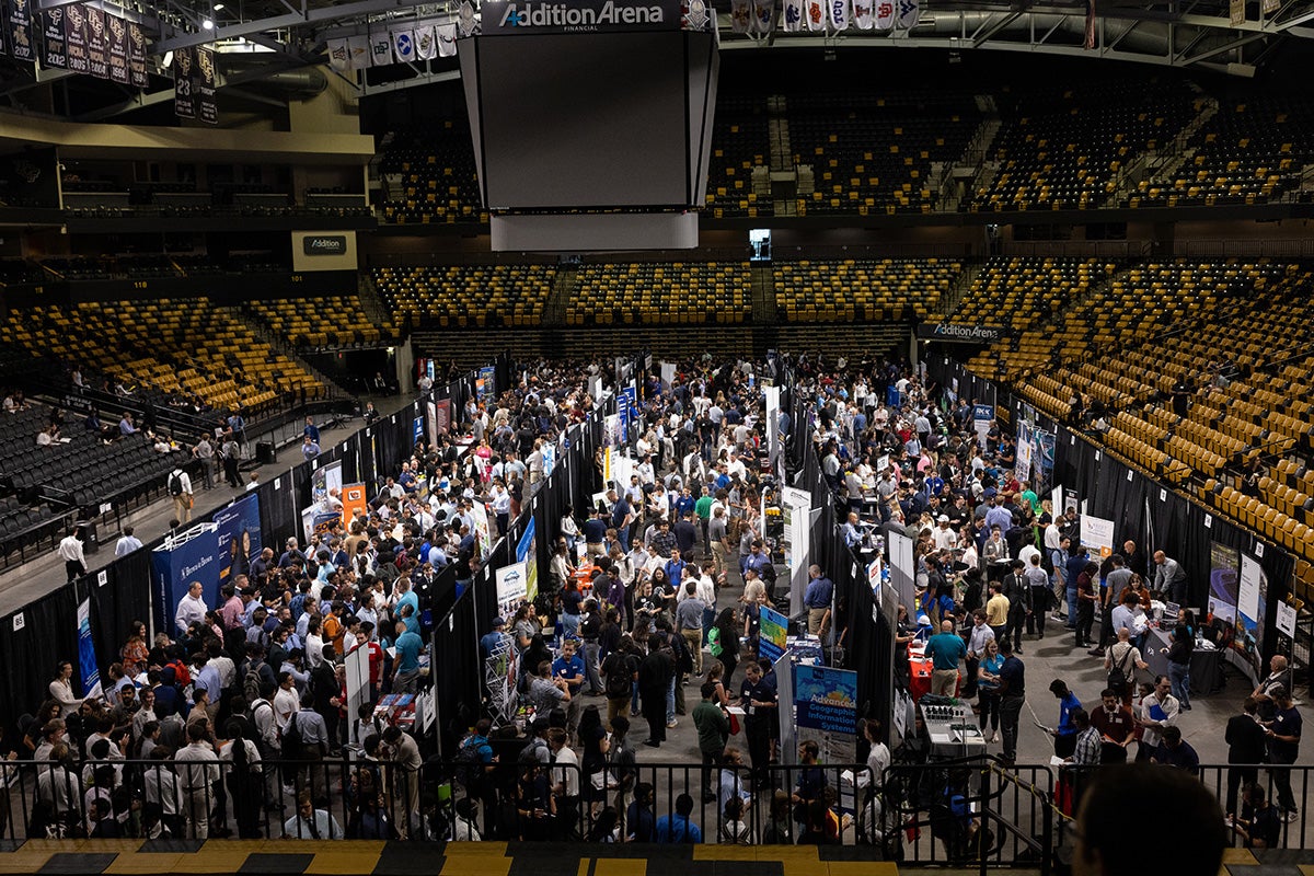Overhead view of floor of Addition Financial Arena crowded with people at tabling fair