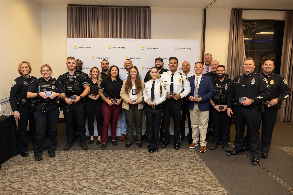 Police officers and people posing for a photo