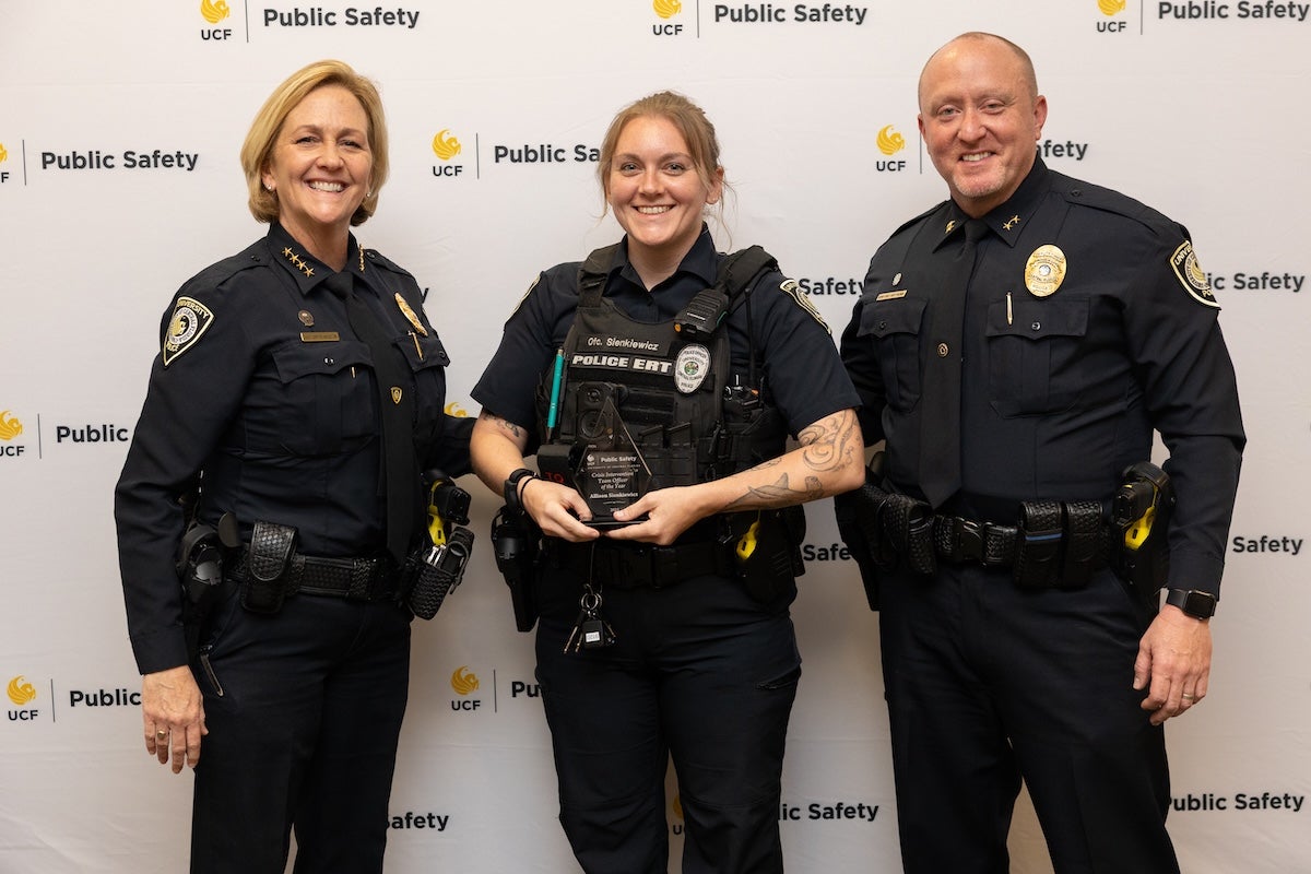Three police officers posing for a photo