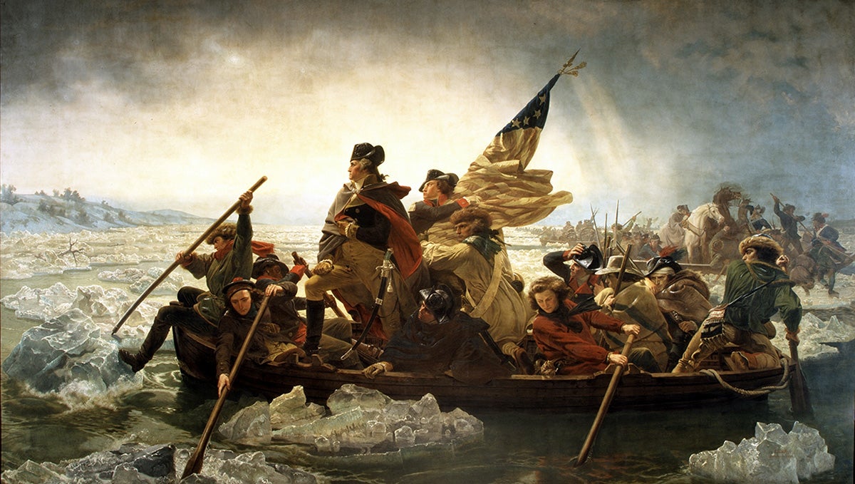 Famous painting of George Washington standing on a boat with American flag crossing icy waters of Delaware River by artist Emanuel Leutze