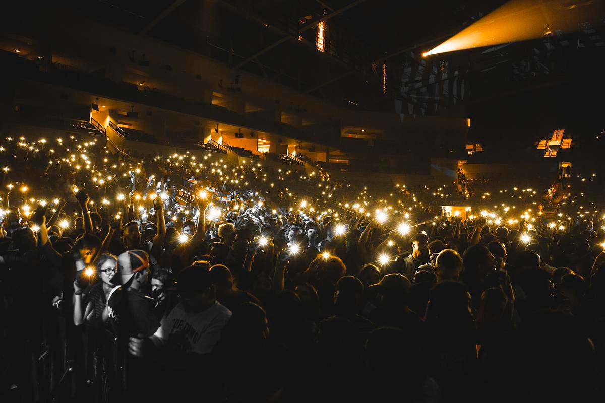 Cell phone lights shine in dark Addition Financial Arena